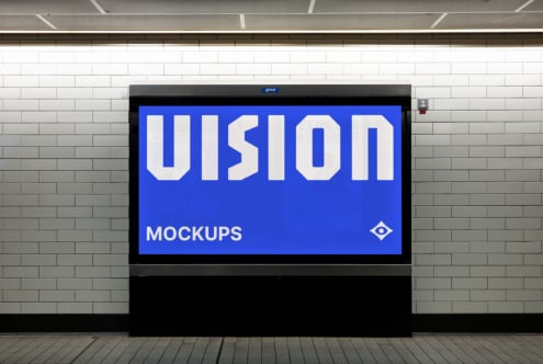 Blue billboard on brick wall displaying VISION in white letters