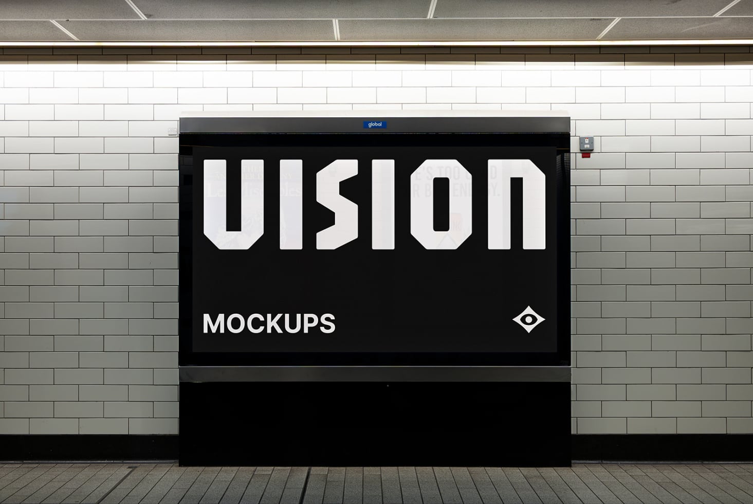 Black billboard on brick wall showing VISION in white letters