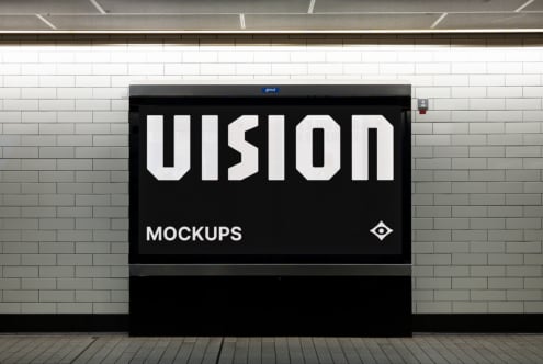 Black billboard on brick wall showing VISION in white letters