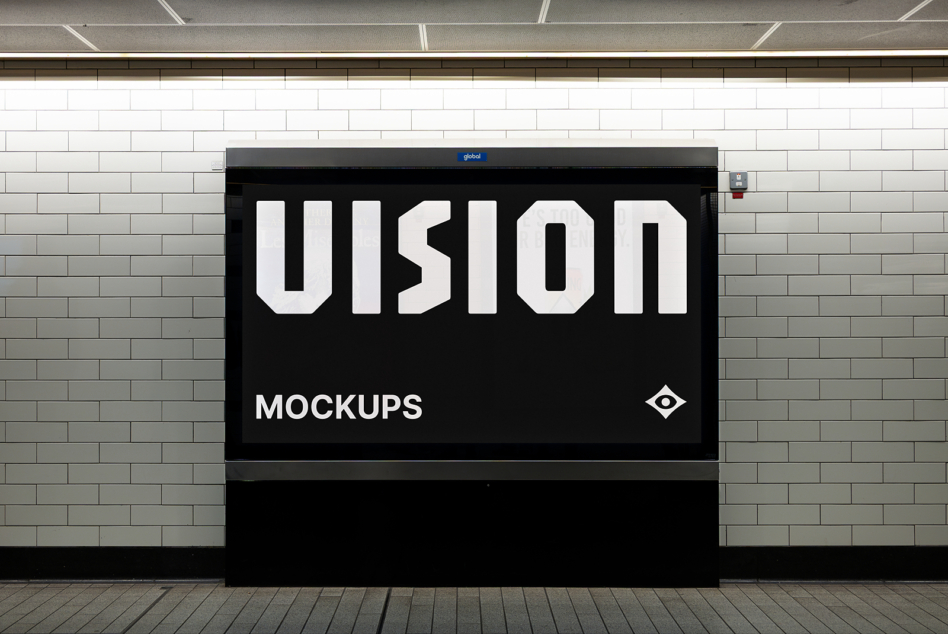 Black billboard on brick wall showing VISION in white letters