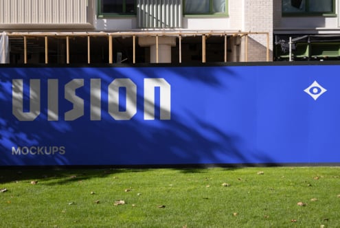 Blue storefront sign with VISION lettering, metal frame on lawn