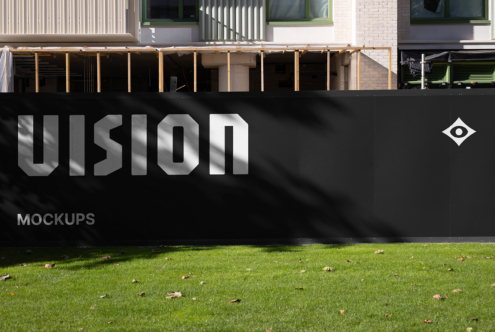 Black storefront sign with VISION lettering, metal frame on lawn