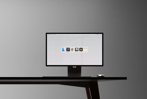 Modern desktop computer mockup displaying design apps on screen. Minimalist workspace setup for digital designers. Ideal for showcasing app interfaces.