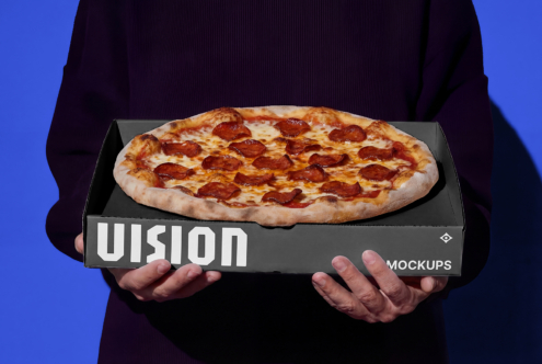 Hands holding dark gray pizza box mockup with pepperoni pizza showing