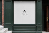 Storefront window with green frame displaying Mockup Lab logo on white wall