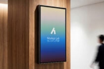 Wall-mounted screen displaying gradient from cream to teal with Mockup Lab branding