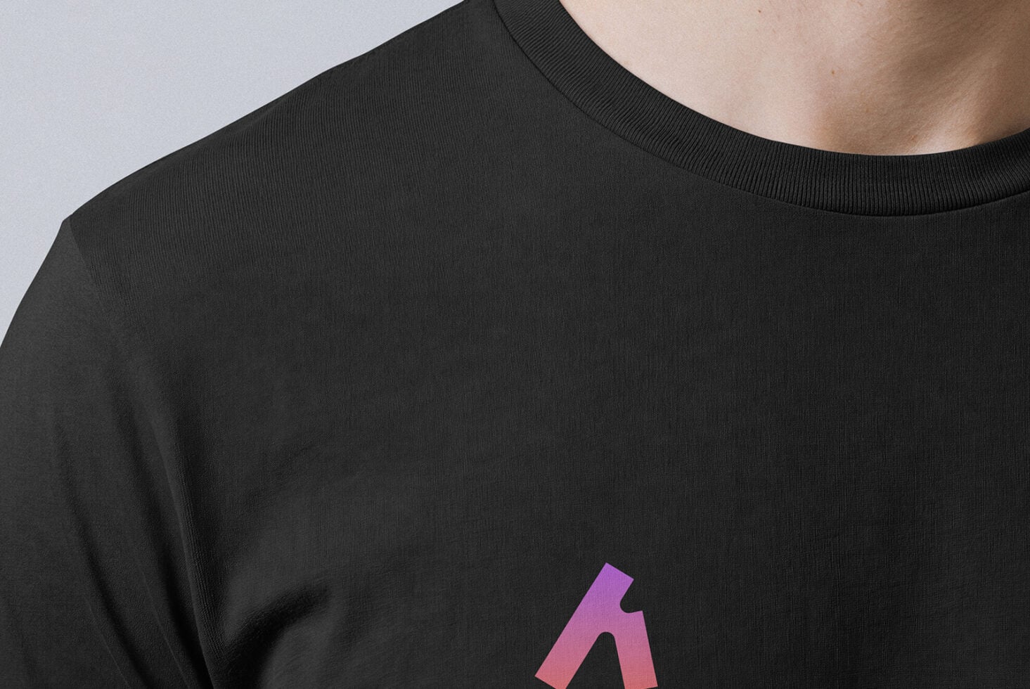 Man wearing black shirt with gradient logo centered