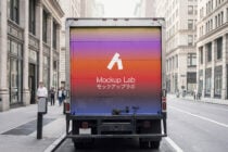 Delivery truck back display with vibrant gradient sunset colors between buildings