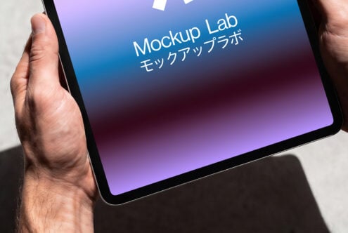 Tablet in hand showing gradient blue to purple screen with Mockup Lab branding