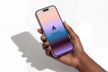 Hand holding phone with gradient peach to purple screen displaying Mockup Lab branding