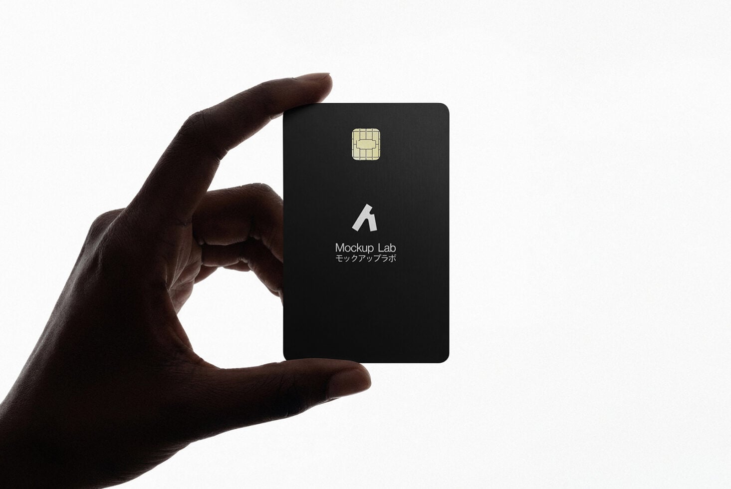 Dark credit card mockup held in fingers against white backdrop