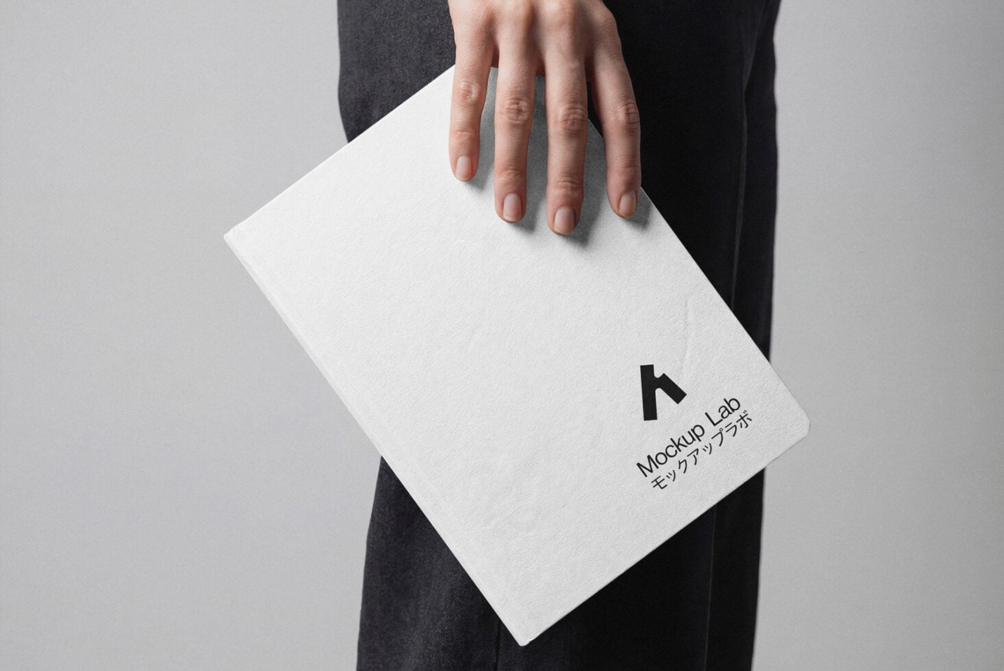 Person holding white card mockup with minimal branding