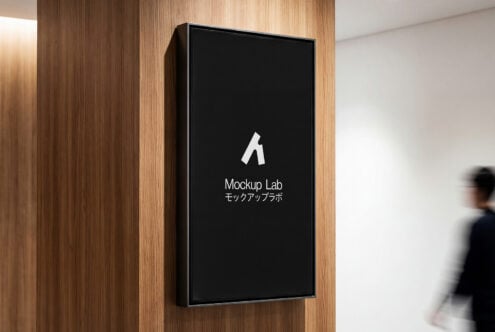 Vertical display on wood wall with black screen, white icon, Mockup Lab text