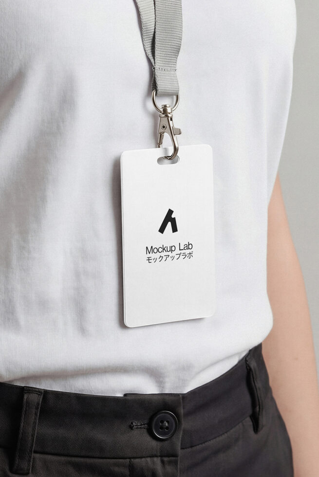White ID badge with gray lanyard clipped to white shirt, showing Mockup Lab logo