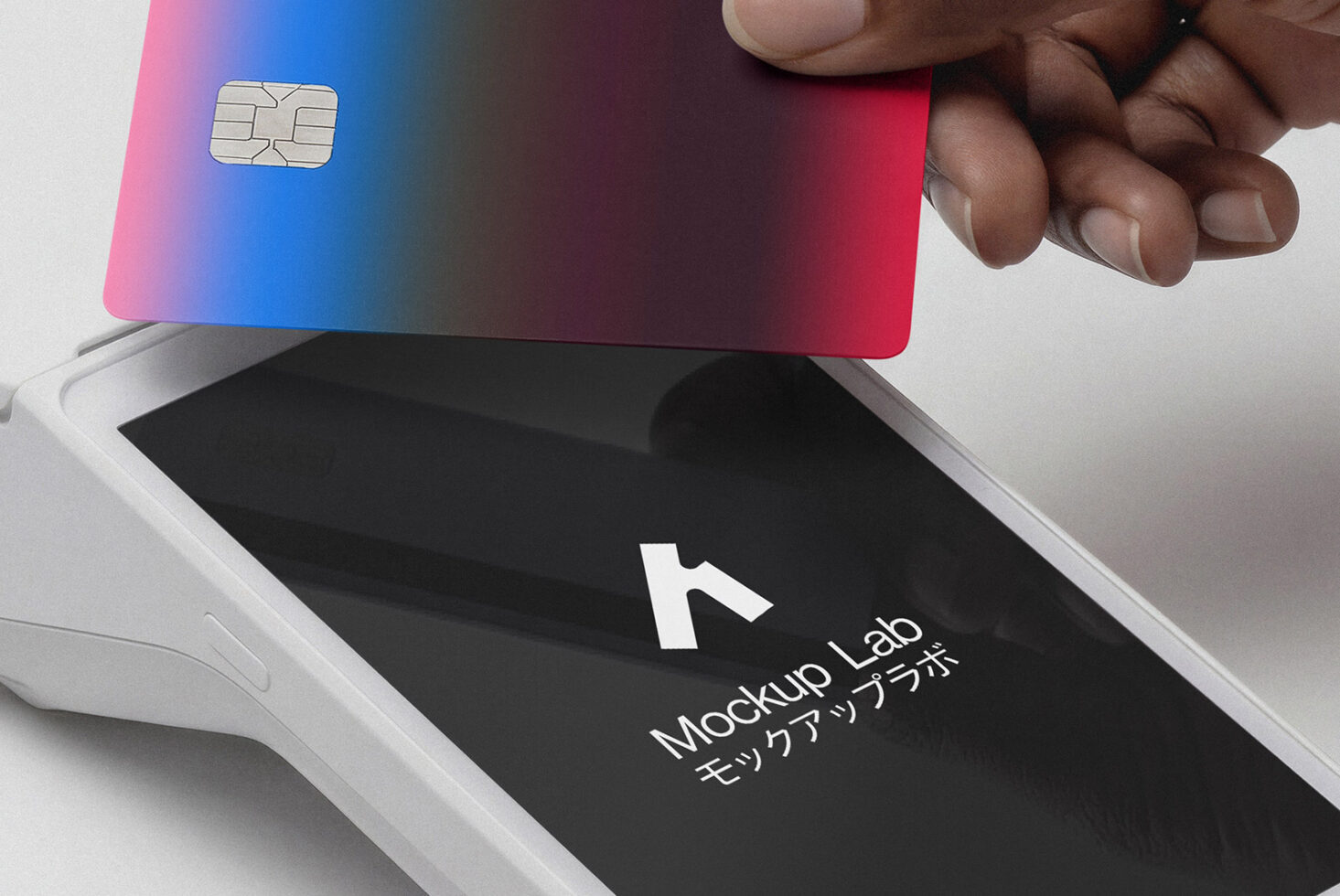 Hand holding gradient credit card above payment terminal with Mockup Lab branding
