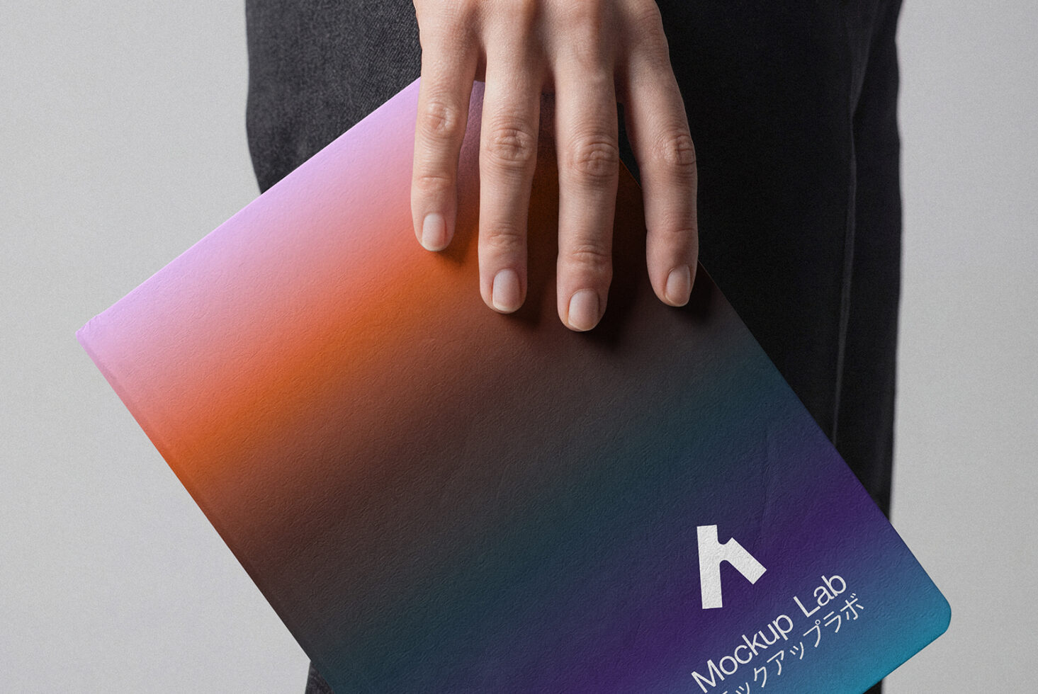 Hand holding curved notebook with gradient pink to teal design