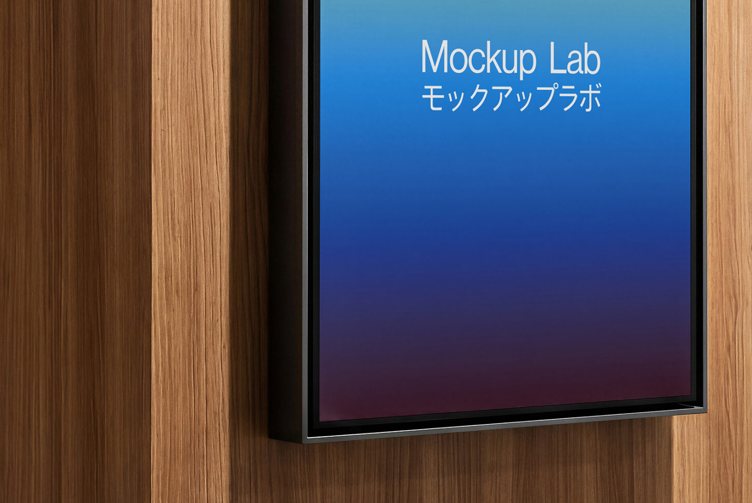 Monitor mounted on wood wall showing blue gradient with Mockup Lab logo