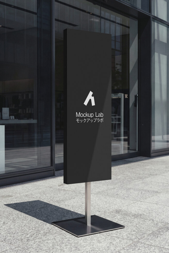 Black outdoor sign post with white logo against modern storefront