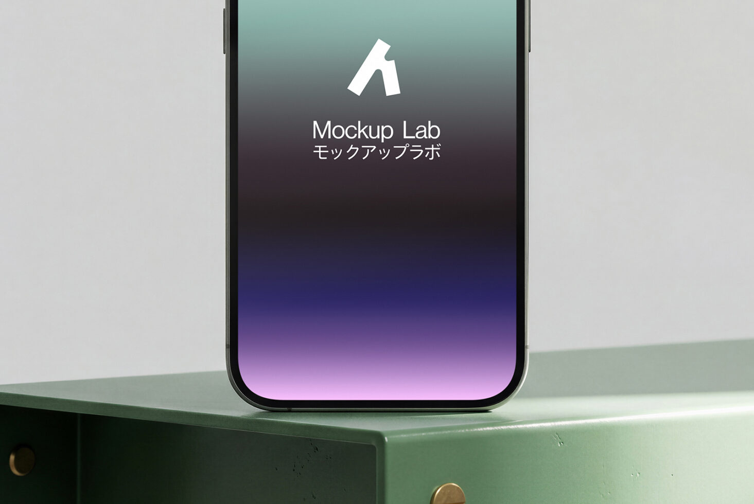 iPhone on green surface showing Mockup Lab splash screen with teal to purple gradient