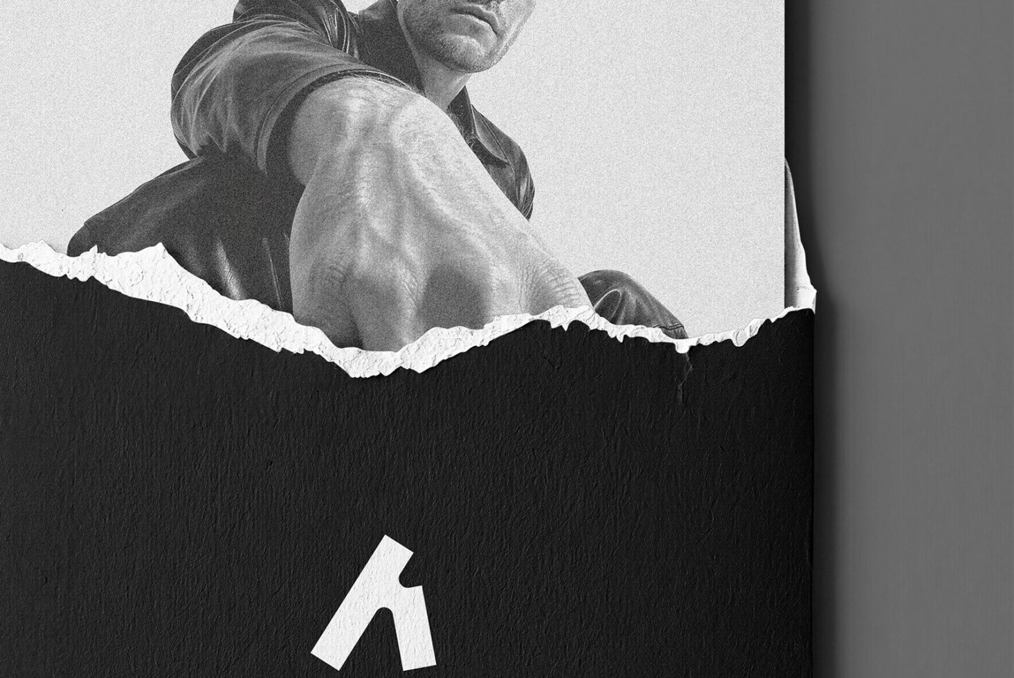 Black torn paper effect revealing portrait of man in monochrome