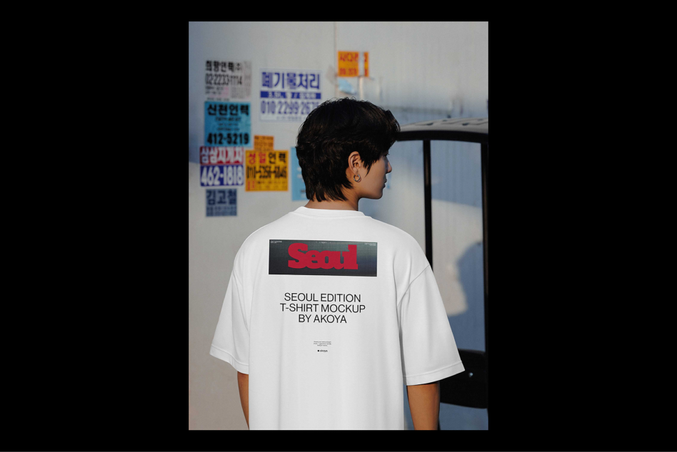 Seoul Edition T-shirt mockup featuring a young person in a white tee with bold red text and urban ambiance. Ideal for fashion designers and graphic projects.