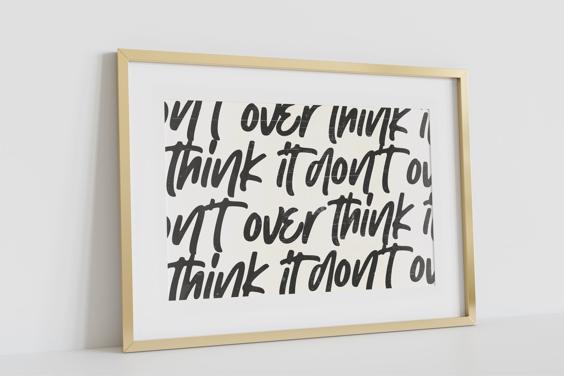 Gold wood frame on white wall with handwritten text about overthinking