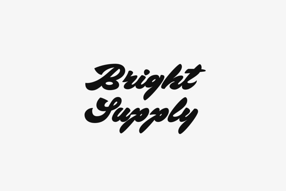 Bold script lettering reading Bright Supply in black on light background