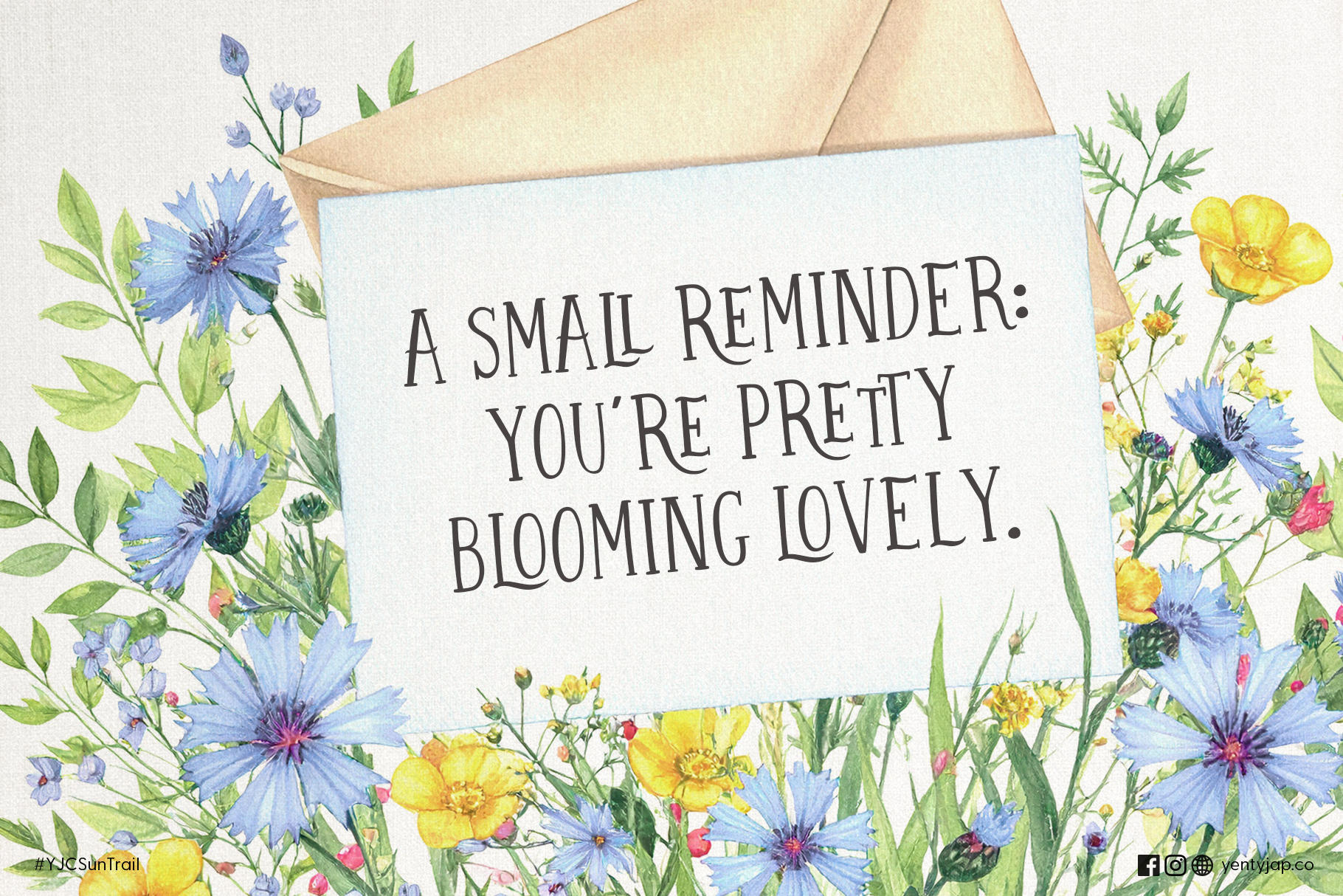Flat lay note card surrounded by blue, yellow, pink wildflowers with motivational text about blooming