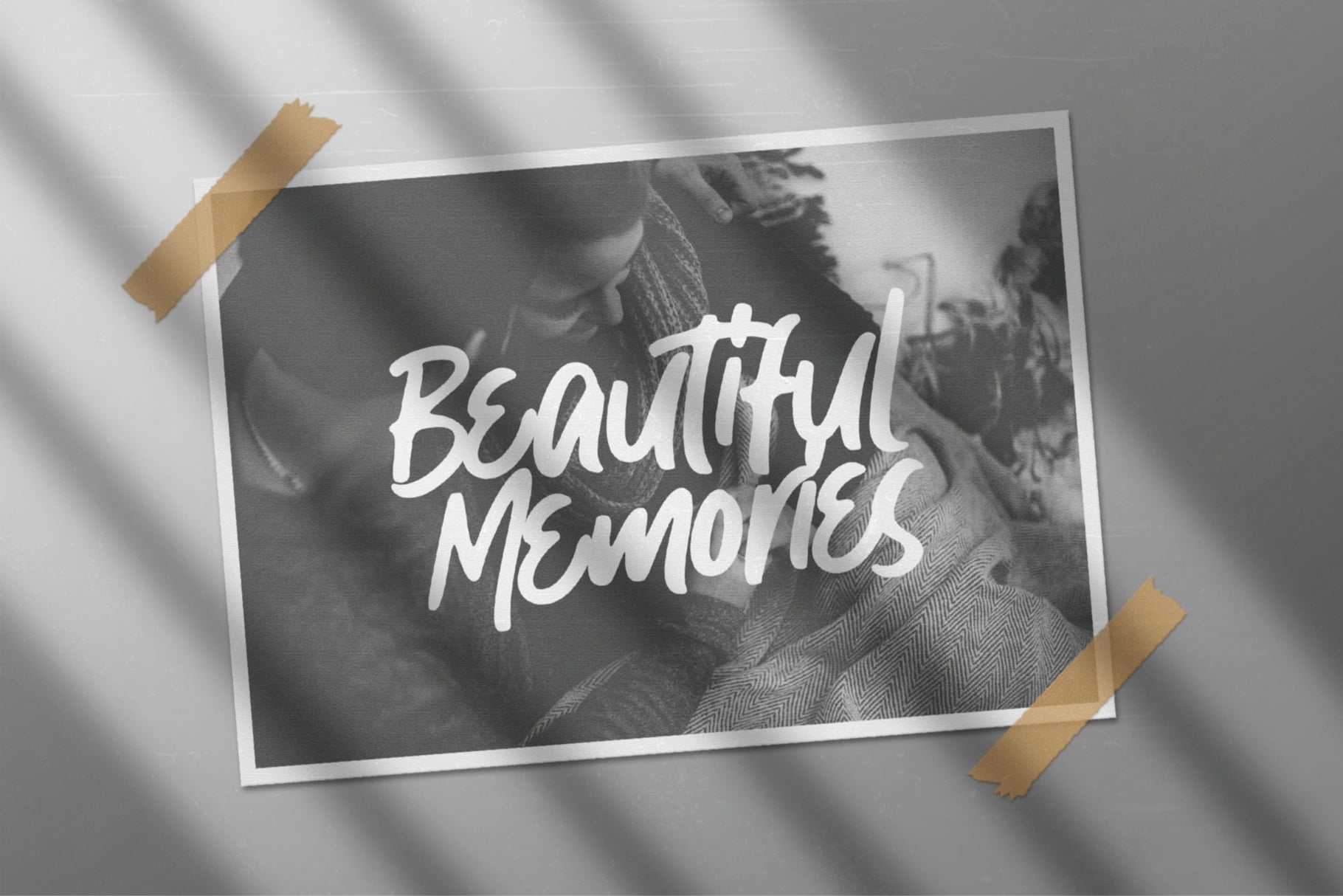 Black white photo taped to wall with handwritten script reading beautiful memories