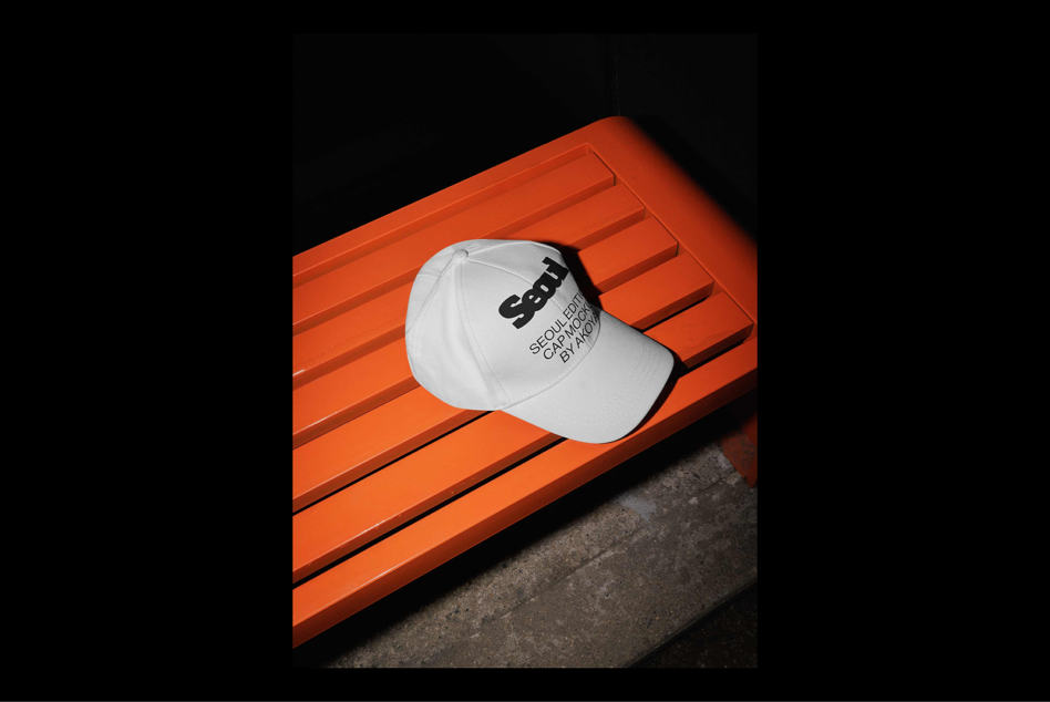 White cap mockup on orange bench perfect for design showcase in templates and graphics categories ideal for branding digital assets designers.
