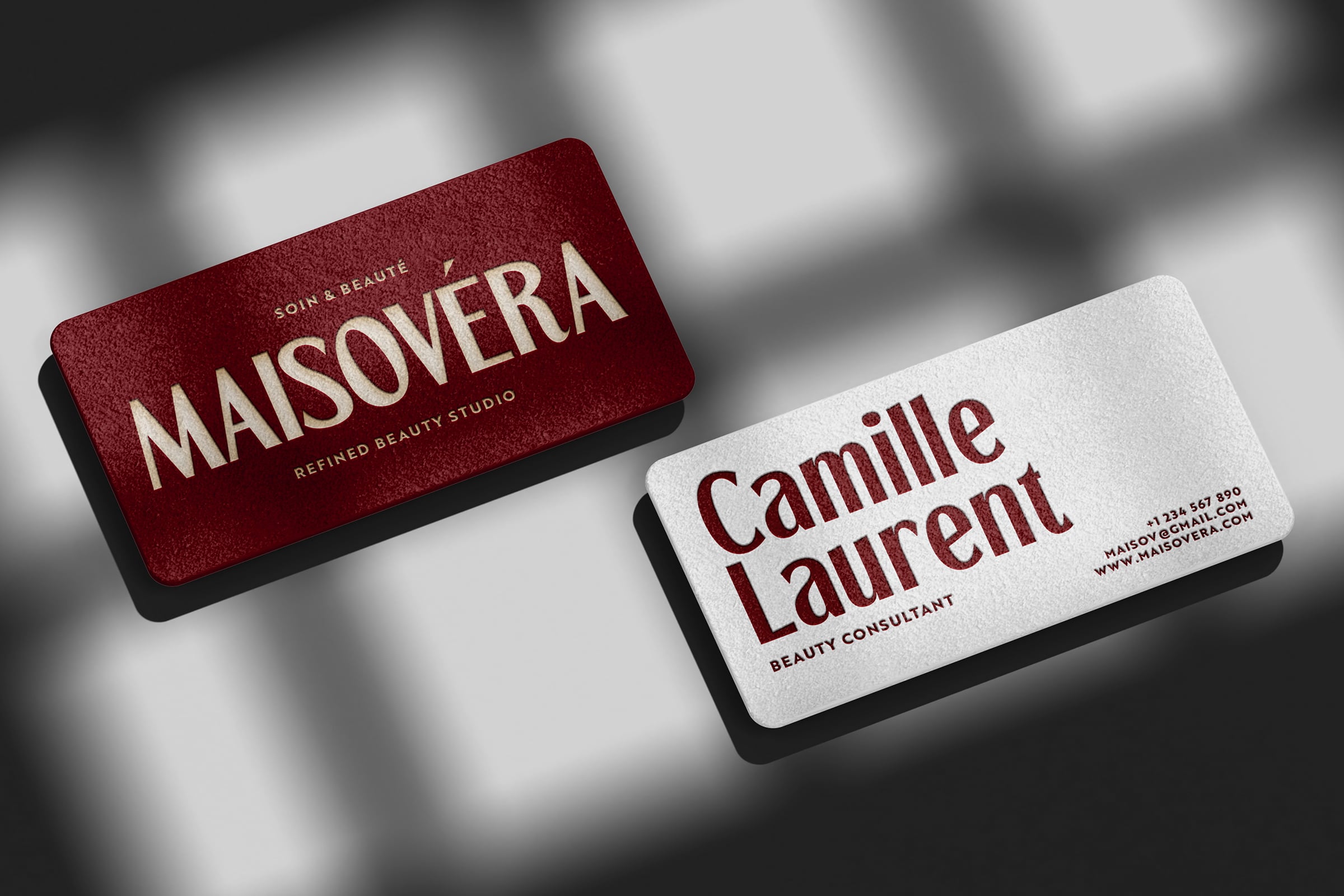 Two business cards red burgundy white layout beauty studio branding