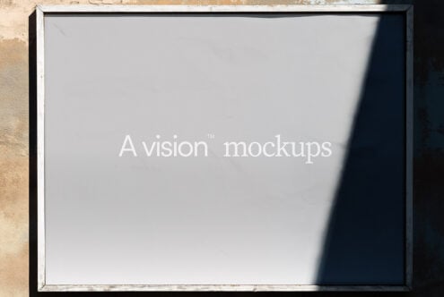 Weathered white frame mounted on textured wall displaying A vision mockups text