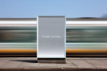 Bus shelter billboard mockup with empty gray display surface outdoors