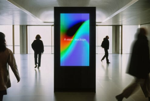 Digital billboard in modern corridor showing colorful gradient with A vision mockups text