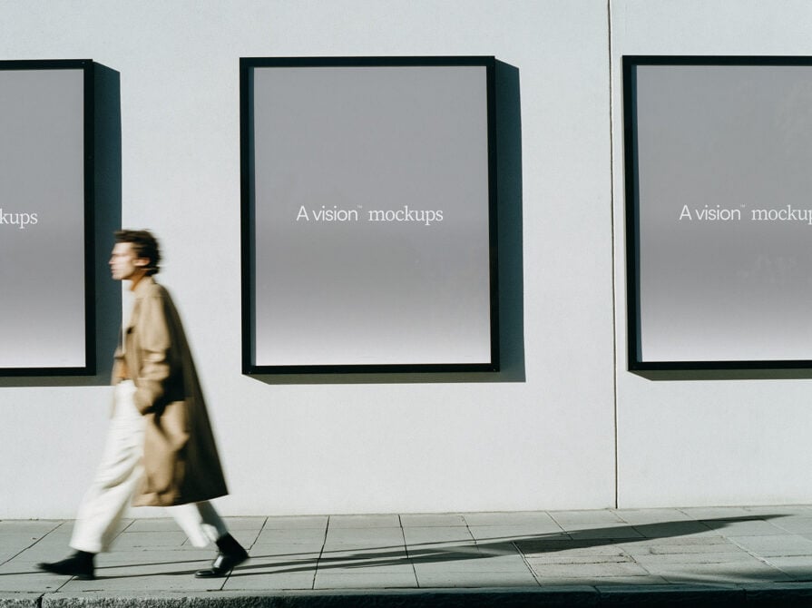 Woman walking past three framed displays with gray backgrounds on modern gallery wall