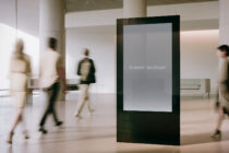 Blank vertical screen display in minimalist gallery with soft natural lighting