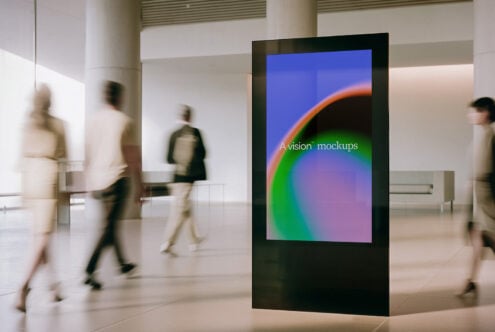 Vertical digital display showing colorful gradient with text overlay in modern gallery space