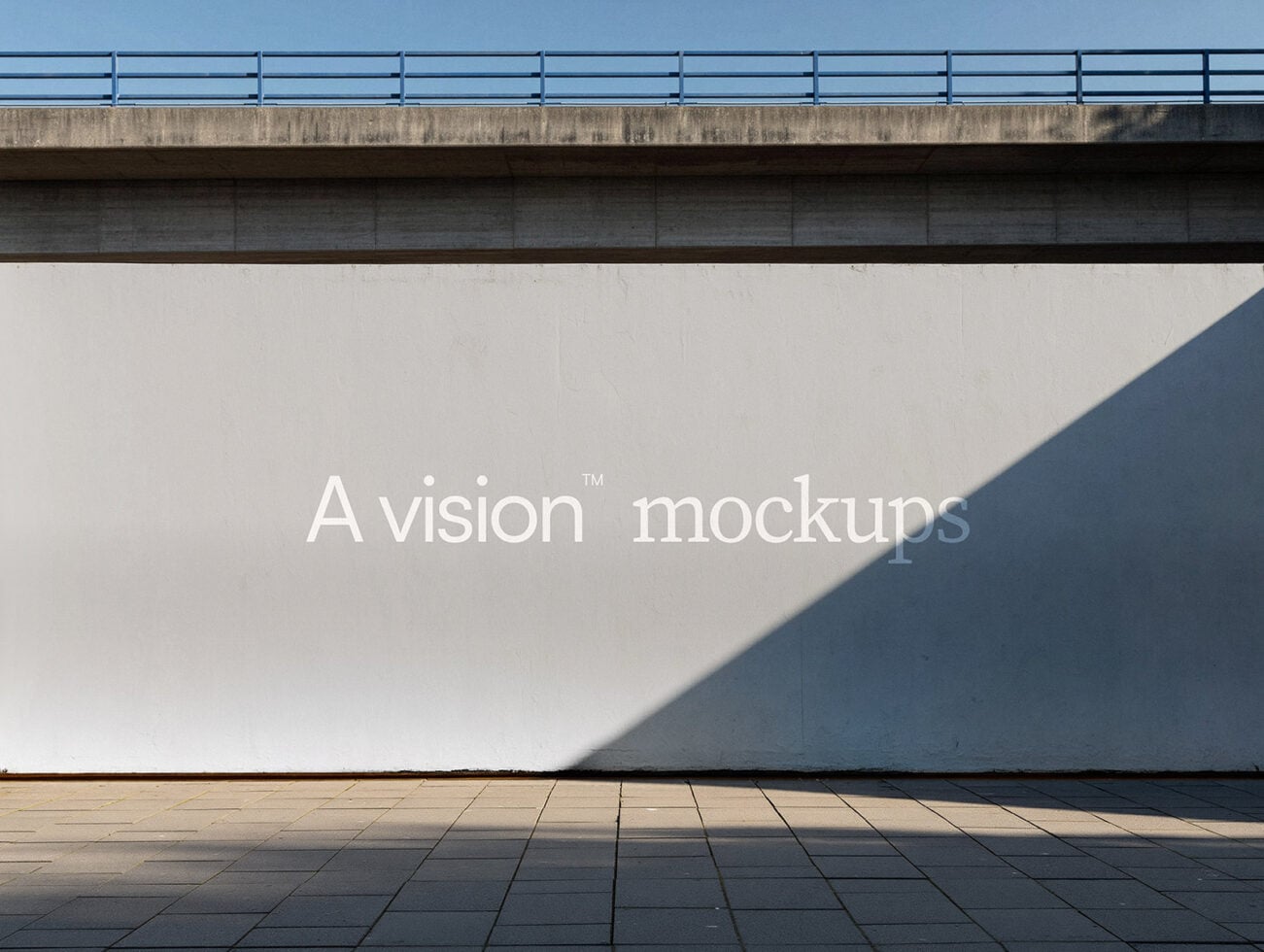 Concrete billboard under overpass with white text on neutral beige wall