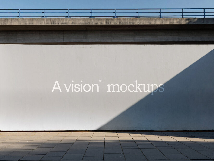 Concrete billboard under overpass with white text on neutral beige wall