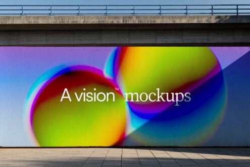 Colorful gradient spheres with rainbow halos on concrete wall under bridge
