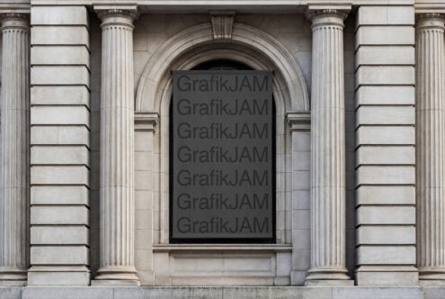 Dark poster on classical stone building facade with columns, ready for design