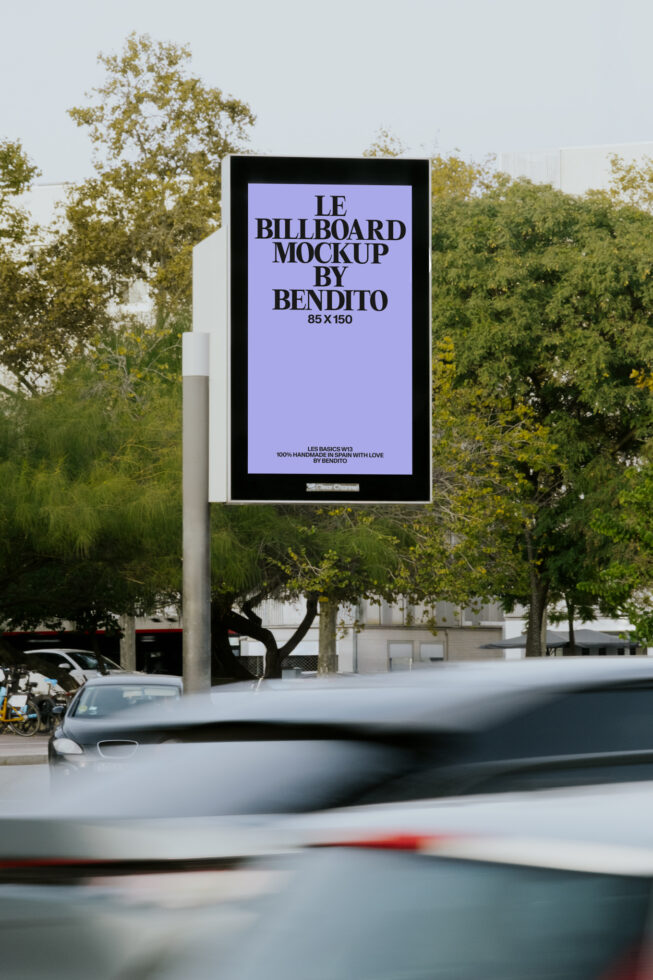 Street billboard with lavender panel against urban trees, passing car in foreground