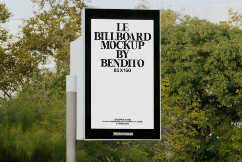 Street billboard on white post with pale background against natural landscape