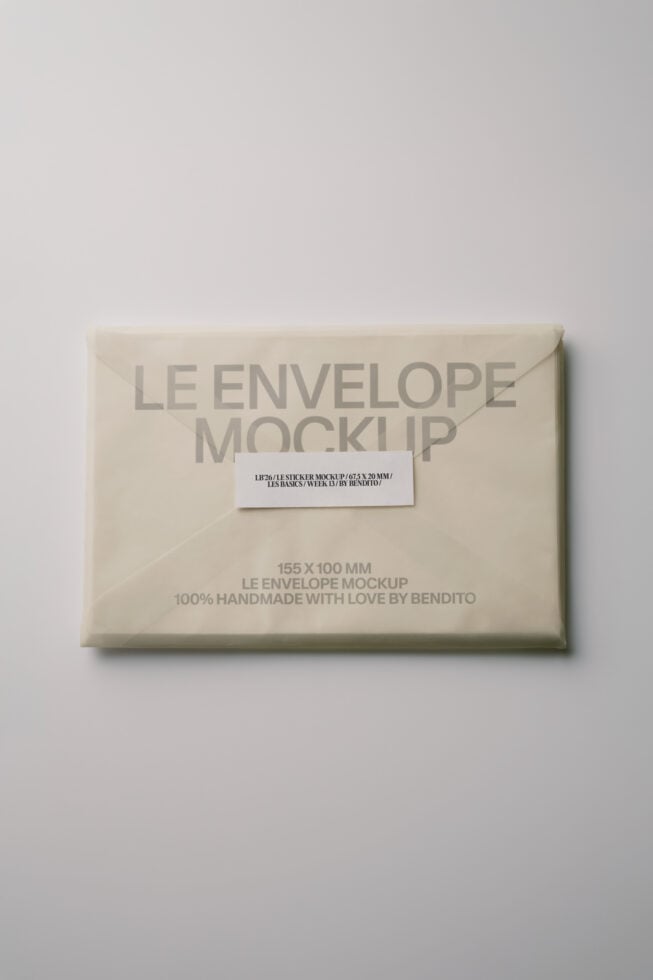 Cream envelope with white label, text reads 155X100MM LE ENVELOPE MOCKUP