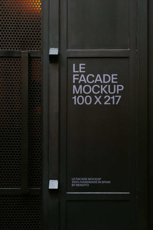 Dark storefront door with perforated metal panel beside white text on black panel