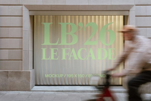 Storefront window display with green text reading LB'26 LE FACADE on golden rippled backdrop