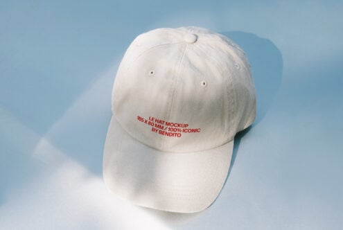 Off white baseball cap in natural light with embroidered text detail
