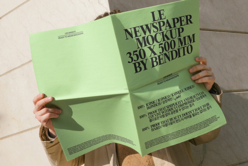 Spread of lime green newspaper mockup held open, vibrant color with small text detail