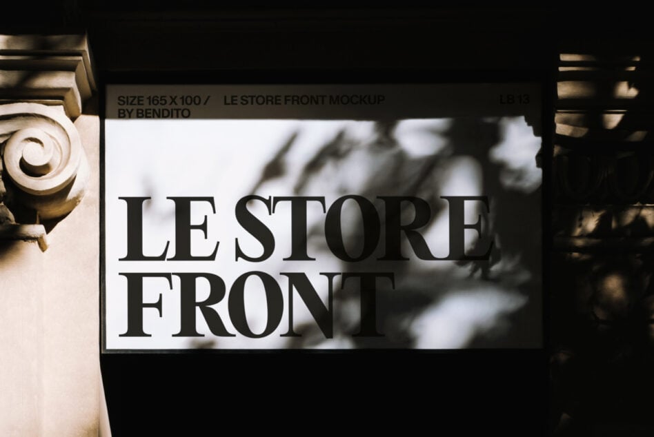 White storefront sign mockup with black serif text, ornate building columns framing