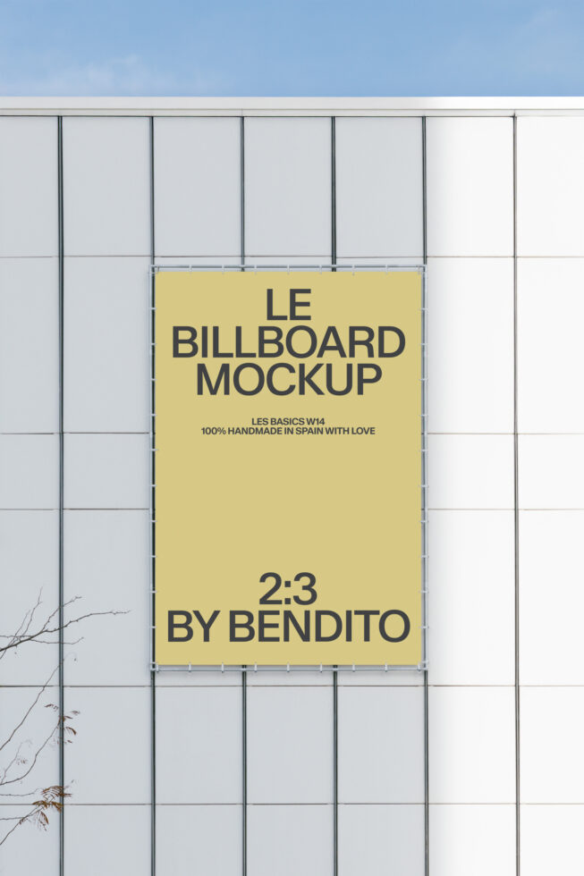 Yellow 2:3 billboard on white metal grid facade with blue sky backdrop